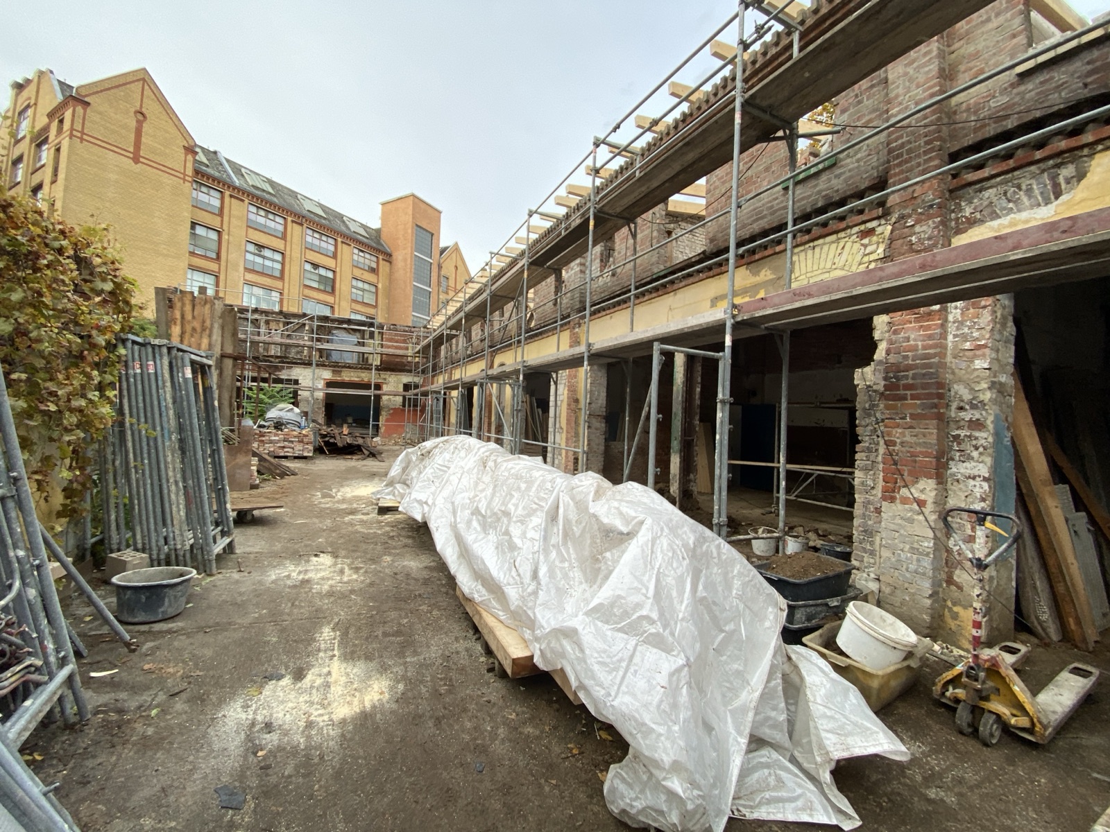 Remise Berlin Umbau – Fassade mit Gerüst, Rundbogenöffnungen freigelegt